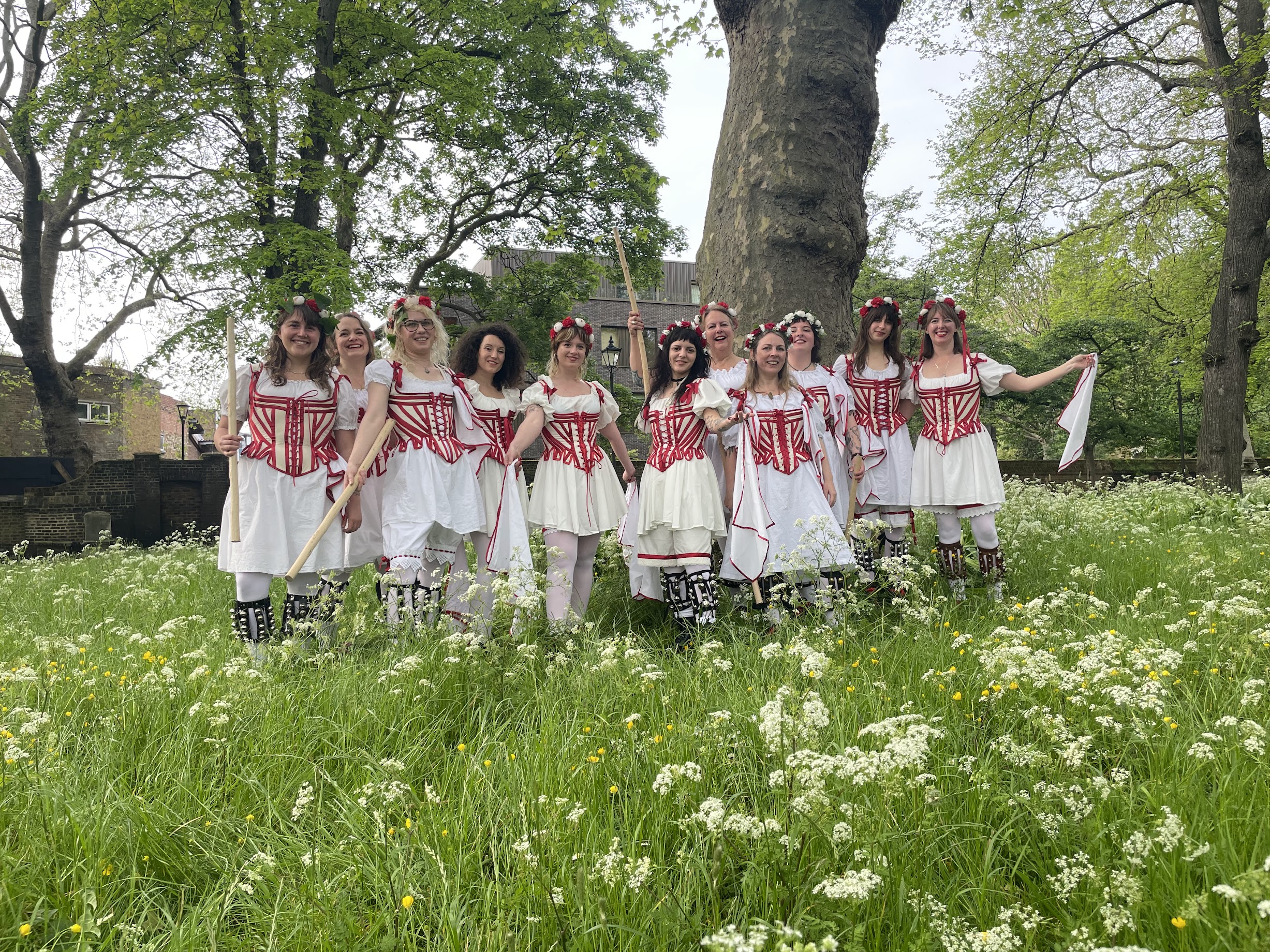 The Belles of London City standing in a field filled with white flowers